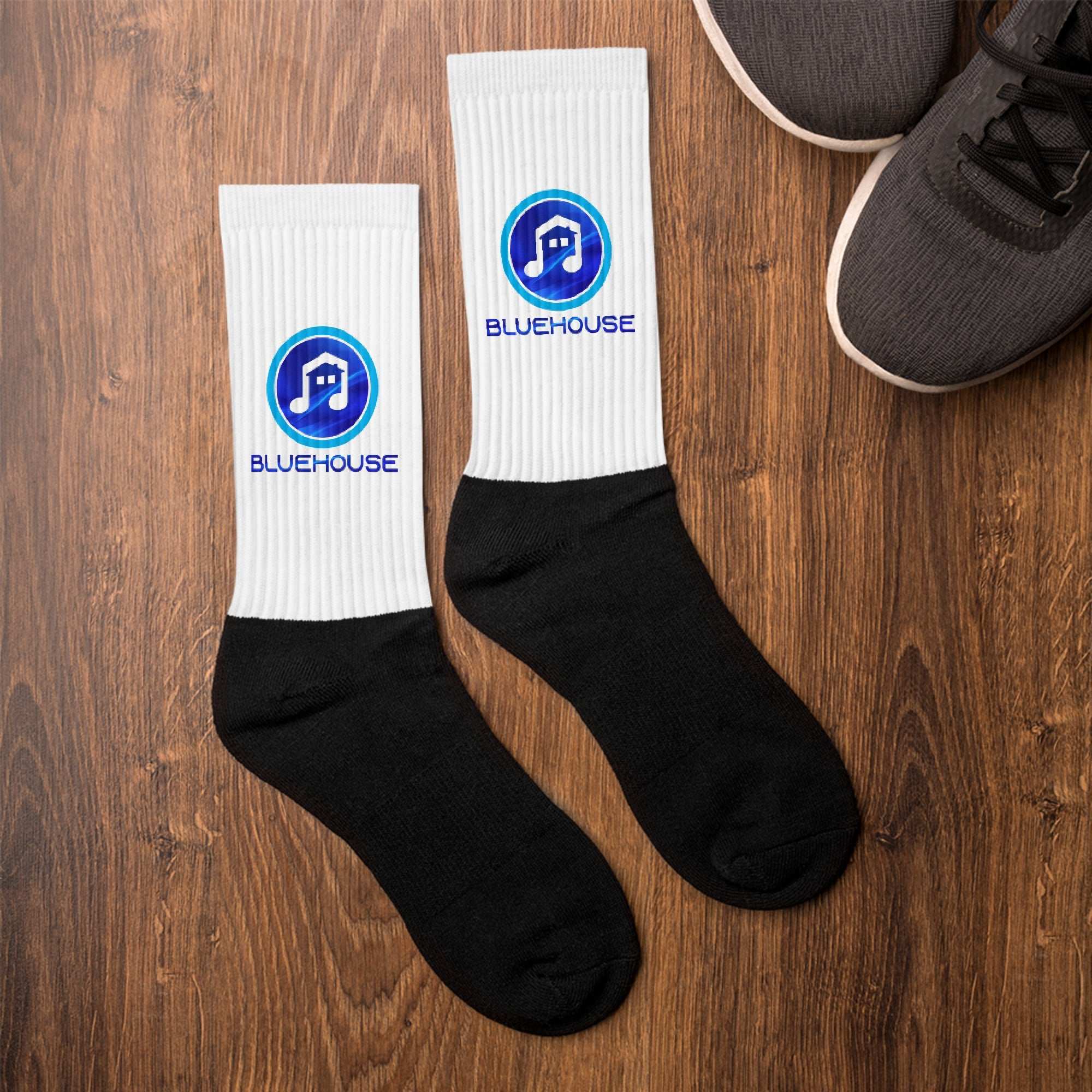 Black cushioned bottom socks with colorful printed artwork and ribbed crew length leg